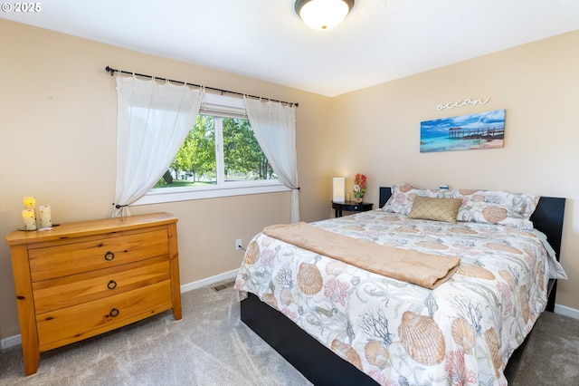 bedroom featuring baseboards, visible vents, and light colored carpet