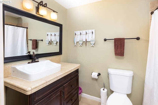 full bath with toilet, baseboards, tile patterned flooring, and vanity