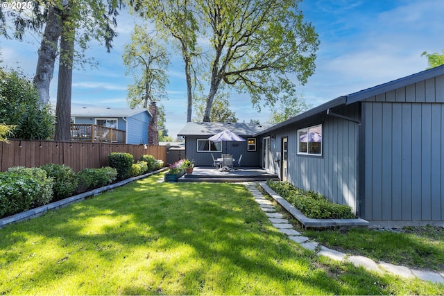 view of yard featuring fence and a deck