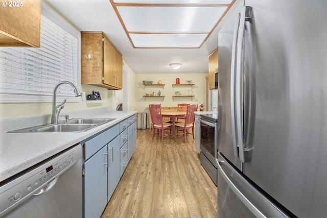 311 S 68th Pl, Springfield, OR 97478 - kitchen featuring stainless steel appliances, light countertops, light wood-style floors, and open shelves