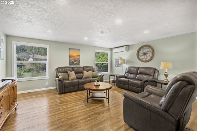 311 S 68th Pl, Springfield, OR 97478 - living room with a wall mounted air conditioner, a textured ceiling, wood finished floors, and recessed lighting