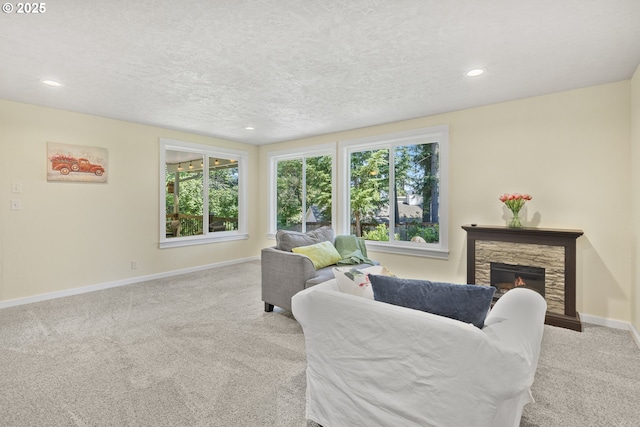 311 S 68th Pl, Springfield, OR 97478 - living area featuring carpet floors, a fireplace, recessed lighting, and a textured ceiling