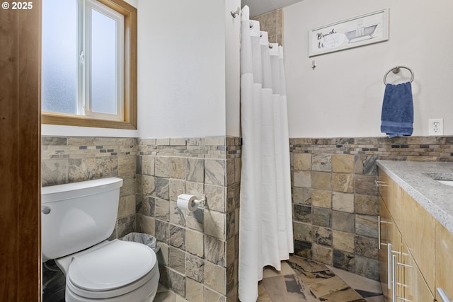 311 S 68th Pl, Springfield, OR 97478 - bathroom featuring tile walls, vanity, a wainscoted wall, and curtained shower