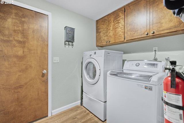 311 S 68th Pl, Springfield, OR 97478 - laundry area featuring washer and dryer, cabinet space, and light wood finished floors