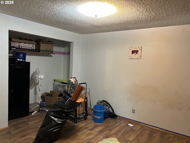 interior space featuring dark hardwood / wood-style floors and a textured ceiling