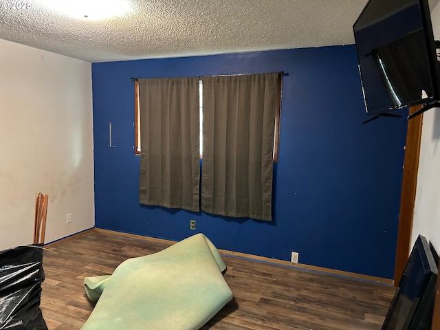 interior space with dark hardwood / wood-style flooring and a textured ceiling