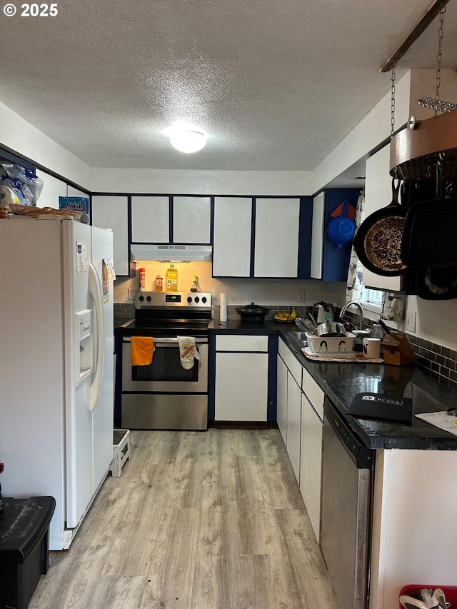 kitchen with white cabinets, sink, light wood-type flooring, a textured ceiling, and stainless steel appliances