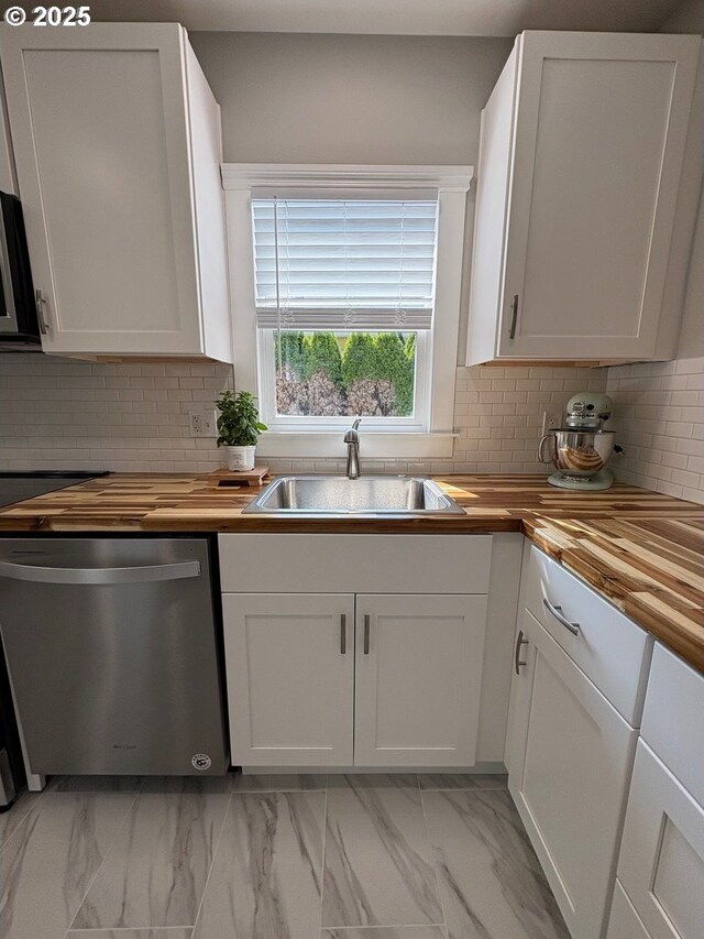 708 W 28th St, Vancouver, WA 98660 - kitchen featuring stainless steel dishwasher, butcher block counters, light marble finish flooring, and white cabinets