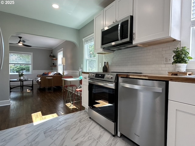 708 W 28th St, Vancouver, WA 98660 - kitchen with stainless steel appliances, butcher block counters, open floor plan, white cabinets, and ceiling fan