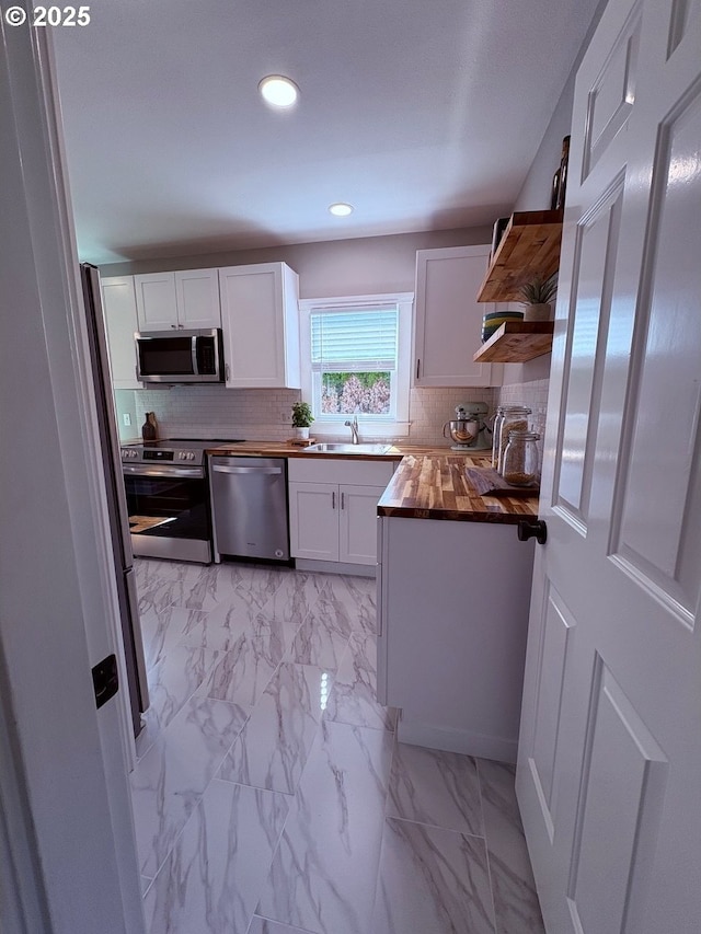 708 W 28th St, Vancouver, WA 98660 - kitchen with appliances with stainless steel finishes, butcher block counters, open shelves, white cabinetry, and recessed lighting