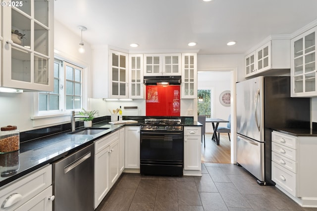 kitchen with under cabinet range hood, stainless steel appliances, a sink, and a healthy amount of sunlight