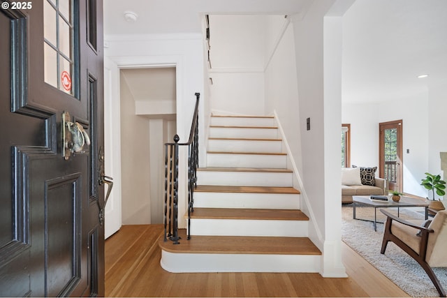 staircase featuring recessed lighting and wood finished floors