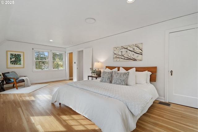 bedroom with light wood-type flooring, visible vents, baseboards, and recessed lighting