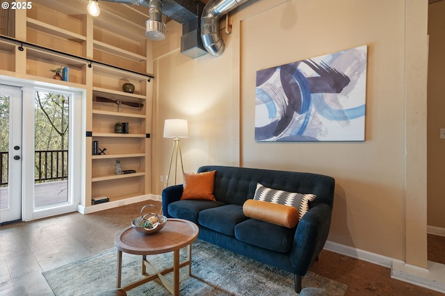 living room featuring baseboards and built in features