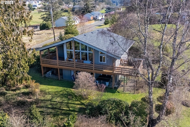 rear view of house featuring stairway, a lawn, and a wooden deck