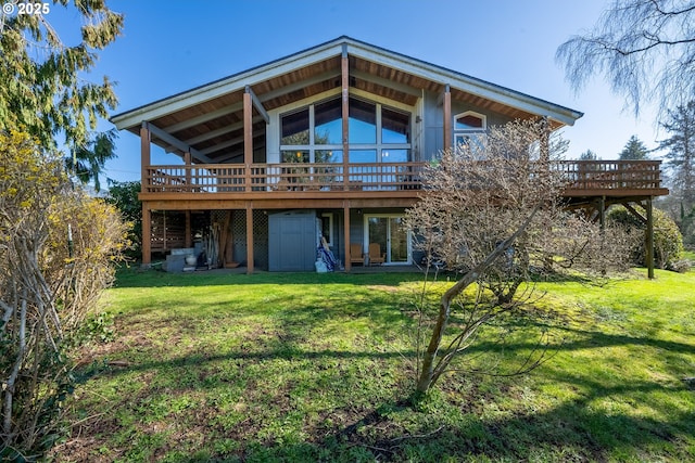 rear view of house with a yard and a deck