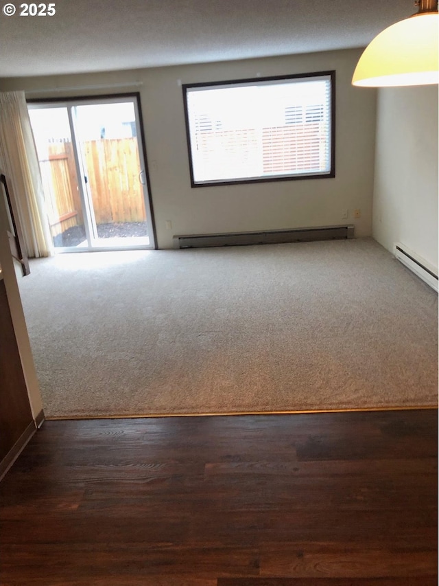 323 S Locust St, Canby, OR 97013 - carpeted empty room featuring a baseboard heating unit