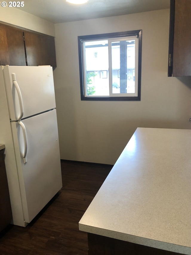 323 S Locust St, Canby, OR 97013 - kitchen featuring freestanding refrigerator, dark wood finished floors, light countertops, and dark brown cabinetry