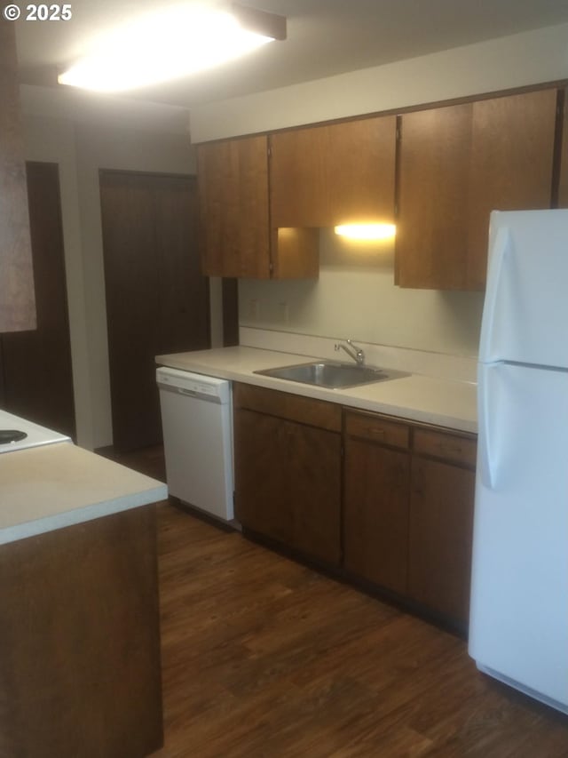 323 S Locust St, Canby, OR 97013 - kitchen featuring white appliances, dark wood-style flooring, light countertops, and brown cabinetry