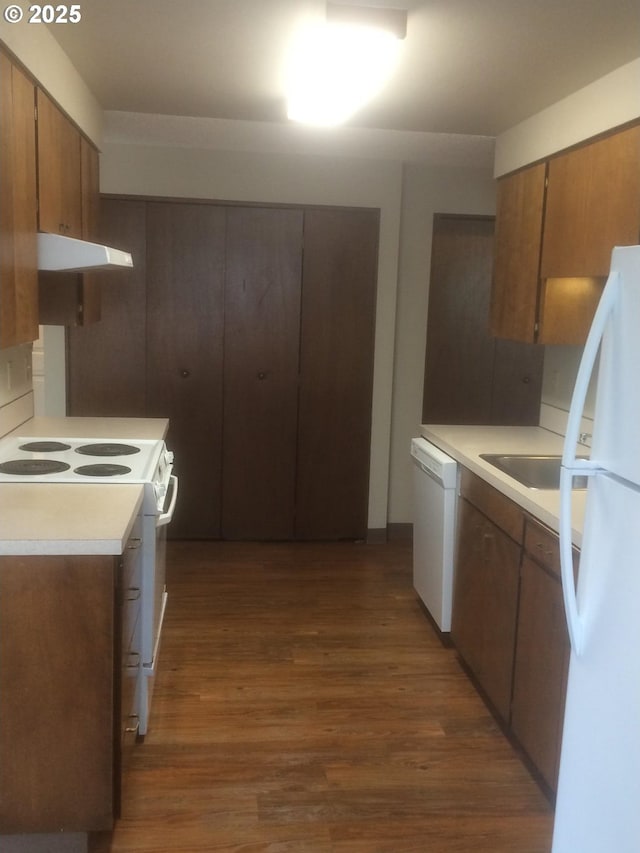 323 S Locust St, Canby, OR 97013 - kitchen featuring white appliances, extractor fan, dark wood-style floors, light countertops, and brown cabinets
