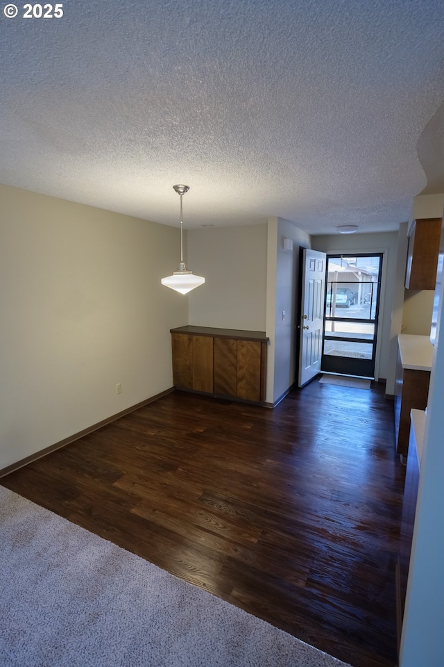 323 S Locust St, Canby, OR 97013 - unfurnished dining area featuring a textured ceiling and dark wood-type flooring