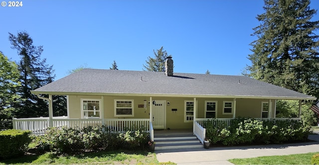 27915 NE Thompson Cir, Yacolt, WA 98675 - view of front facade featuring a porch, a chimney, and roof with shingles