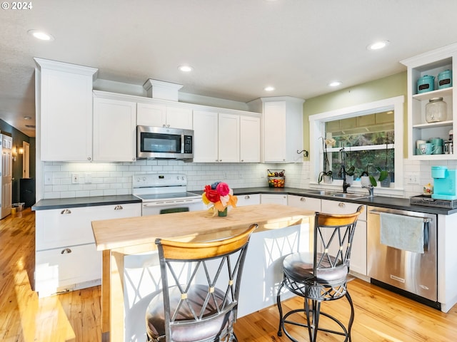 27915 NE Thompson Cir, Yacolt, WA 98675 - kitchen featuring appliances with stainless steel finishes, white cabinetry, tasteful backsplash, and recessed lighting