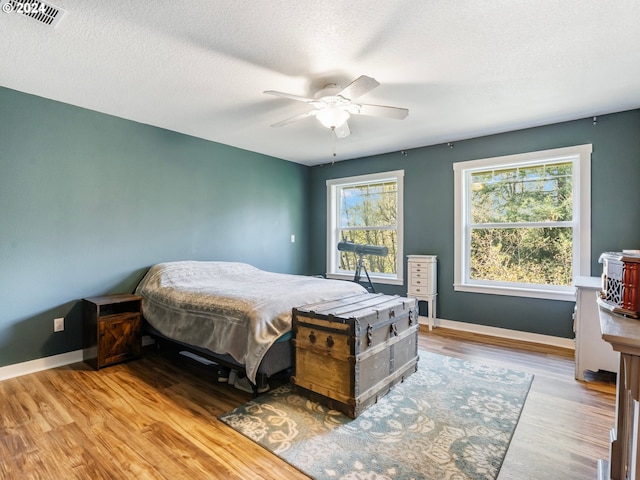 27915 NE Thompson Cir, Yacolt, WA 98675 - bedroom featuring wood finished floors, ceiling fan, and a textured ceiling