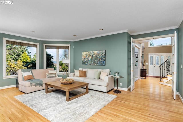 living room featuring light wood-style flooring and crown molding