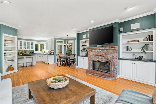 living area with light wood-style floors and ornamental molding
