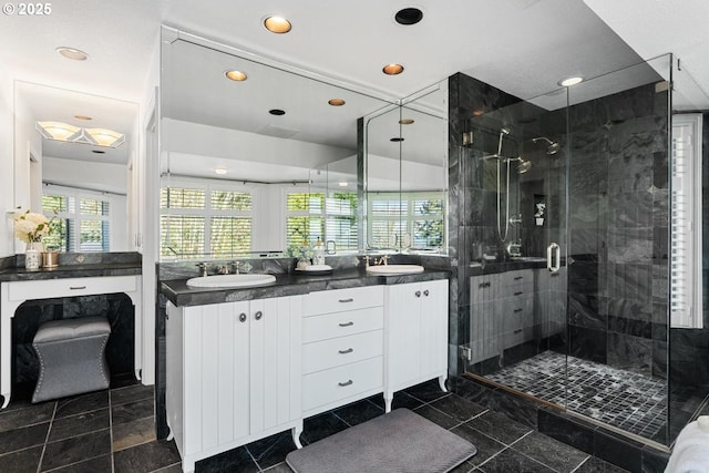 bathroom featuring a sink, recessed lighting, a stall shower, and double vanity