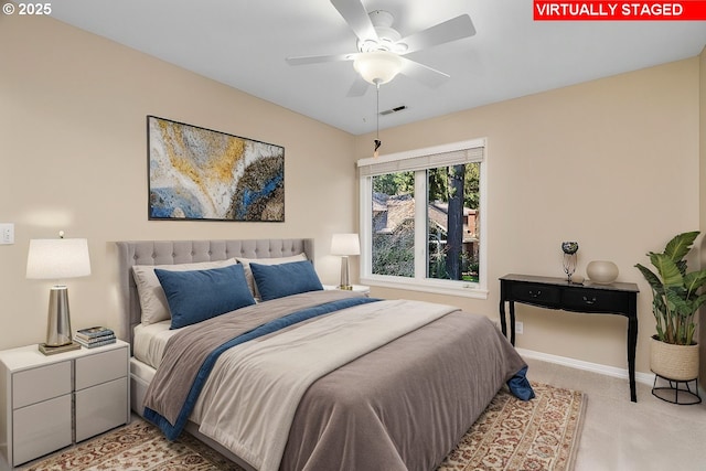 bedroom with baseboards, visible vents, and light carpet