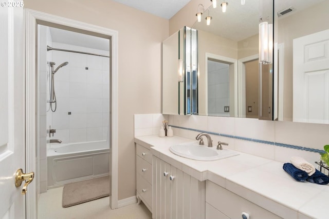 full bath with vanity, tub / shower combination, and tasteful backsplash
