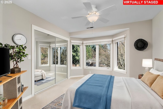 bedroom with visible vents, a ceiling fan, a closet, carpet floors, and baseboards