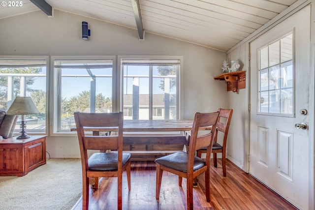 dining room with lofted ceiling with beams and light wood-style floors