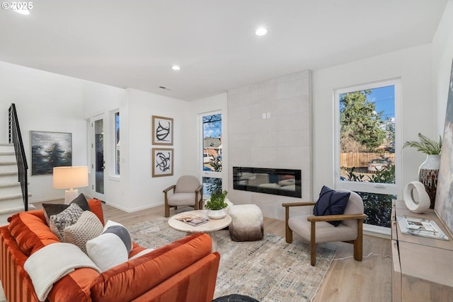 living room with a fireplace and light hardwood / wood-style floors