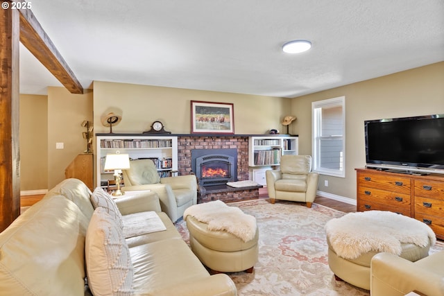 5583 54th Ct, Salem, OR 97317 - living room with wood finished floors, baseboards, a brick fireplace, and a textured ceiling