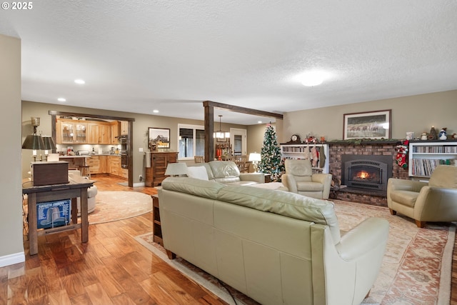 living room featuring light hardwood / wood-style floors and a textured ceiling