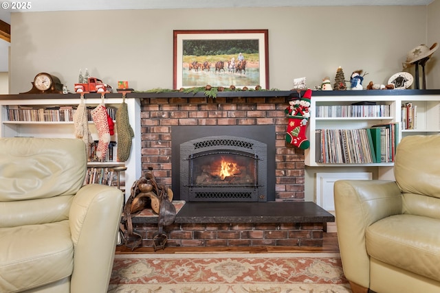 sitting room with a fireplace and light wood-type flooring