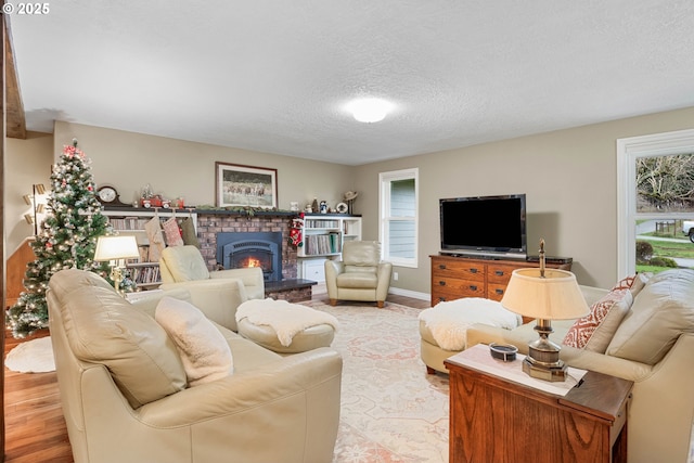 living room with a textured ceiling and light wood-type flooring