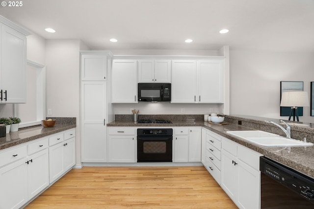 10494 NW Forestview Way, Portland, OR 97229 - kitchen featuring black appliances, a sink, white cabinetry, light wood-style floors, and recessed lighting