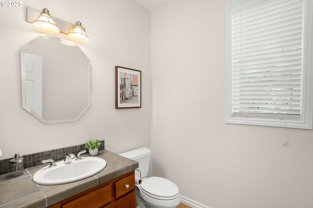 10494 NW Forestview Way, Portland, OR 97229 - bathroom with toilet, vanity, and tasteful backsplash