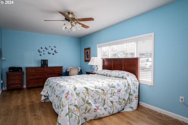 bedroom featuring ceiling fan, baseboards, and wood finished floors