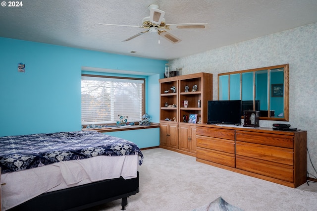 bedroom with visible vents, light carpet, a textured ceiling, and wallpapered walls