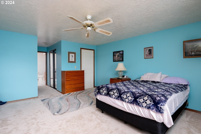 bedroom featuring carpet, ceiling fan, and a textured ceiling