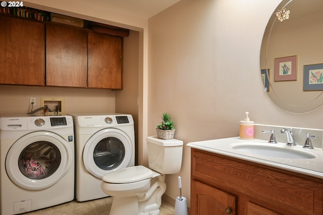 clothes washing area with laundry area, a sink, and washer and dryer