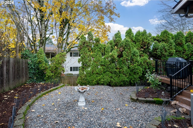 view of yard featuring fence and a deck