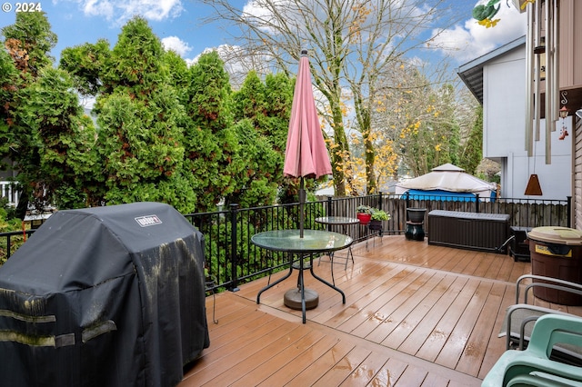 wooden terrace featuring a grill