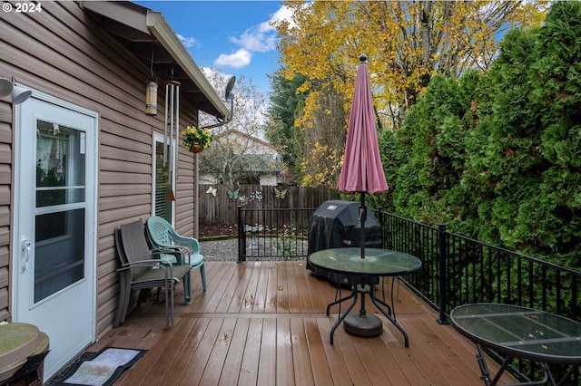 deck with fence and area for grilling