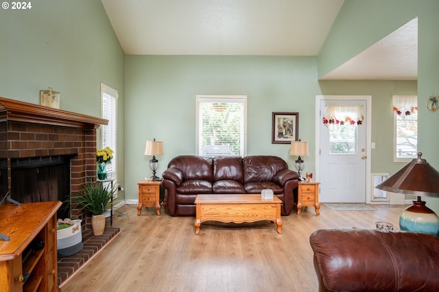 living room featuring lofted ceiling, a wealth of natural light, and wood finished floors